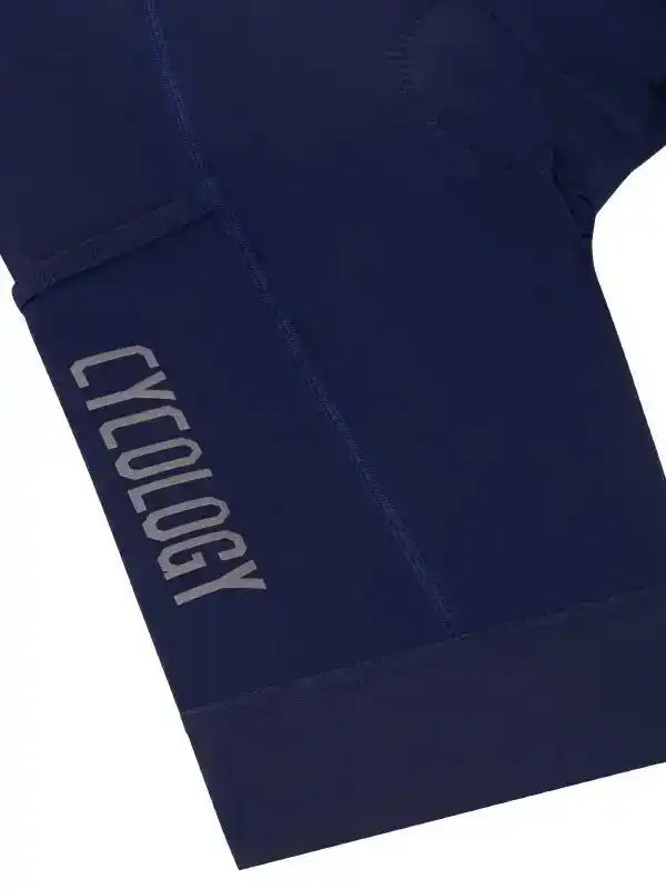 Navy blue cycling shorts with 'CYCOLOGY' logo on leg, designed for men and women riders.