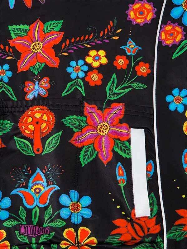 Vibrant floral and butterfly print on black cycling jersey with reflective strip