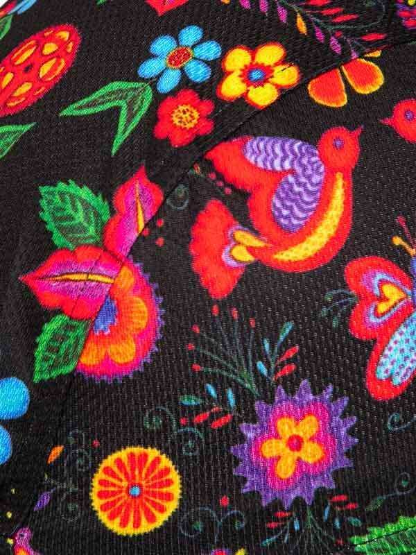 Vibrant floral and bird pattern on black cycling apparel fabric