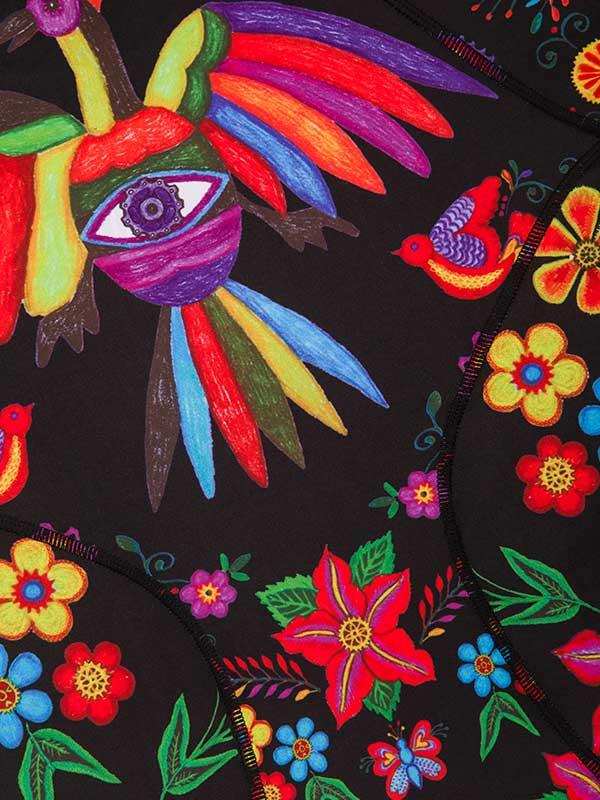 Vibrant floral and bird print on black cycling apparel fabric, featuring colorful flowers and stylized birds.