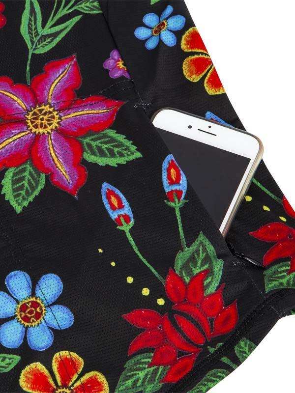 Black cycling shorts with vibrant floral print and phone pocket, ideal for women's bike rides