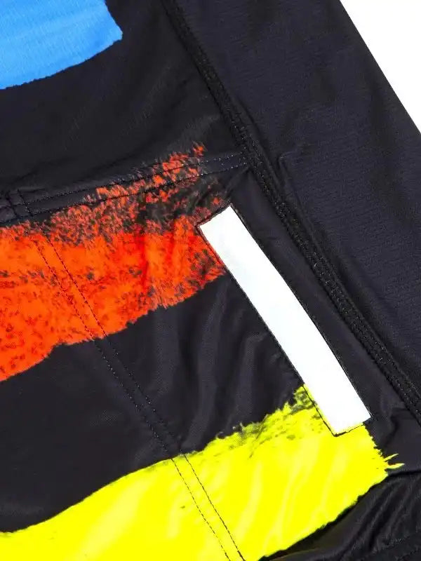Men's cycling jersey with bold orange, yellow, and blue abstract design, reflective strip, and zippered pocket