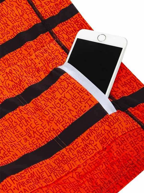 Orange cycling shorts with black stripes and text print, featuring a phone pocket for storage during rides.