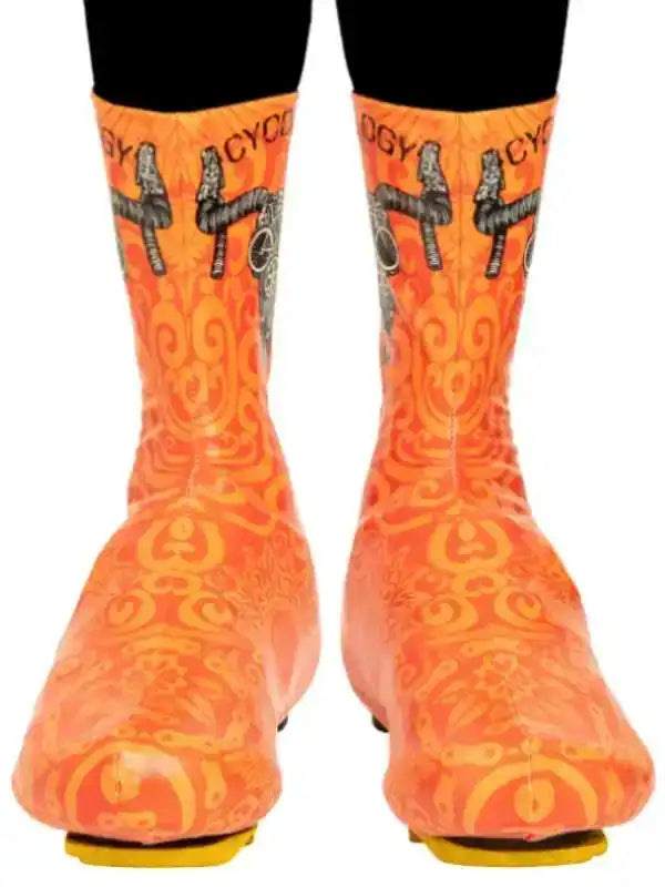 Orange cycling shoe covers with bike graphic and swirl pattern for road biking gear