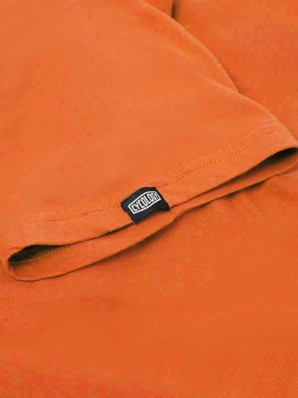 Orange cycling jersey sleeve with black CYCLOGY tag, high-quality fabric detail