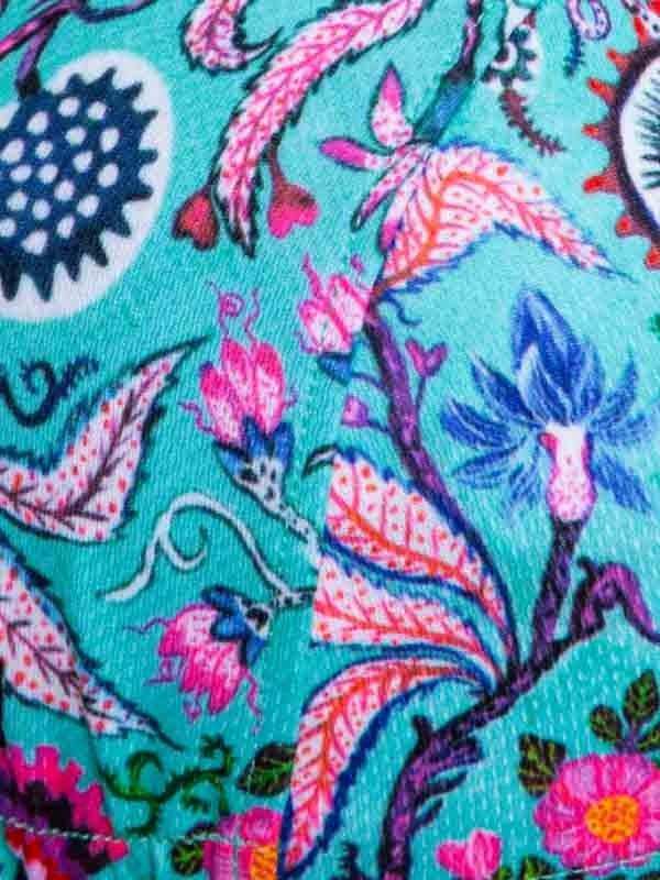 Vibrant floral cycling fabric with pink, blue, and teal botanical print on performance material