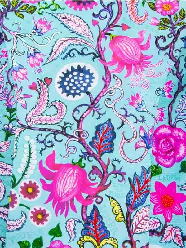 Vibrant floral cycling jersey with pink and blue botanical print on light blue background