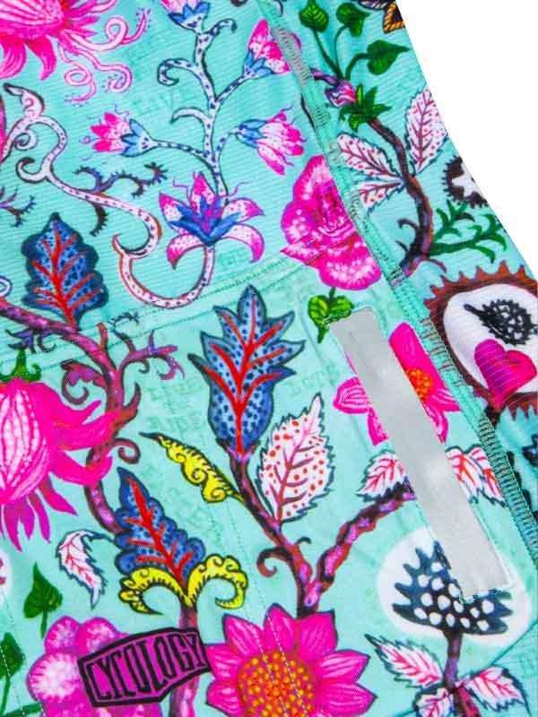 Vibrant floral cycling shorts with pink, blue, and green botanical print and reflective strip