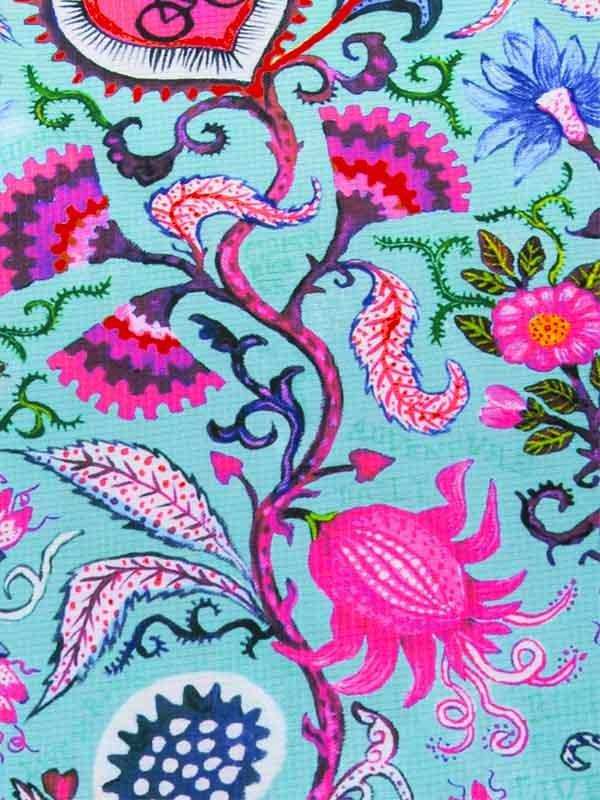 Vibrant floral cycling fabric with pink, blue, and purple botanical print on teal background