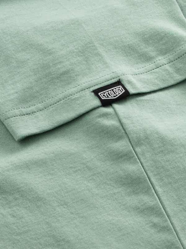 Mint green cycling jersey with Cycology brand tag, soft fabric detail for men's and women's bike wear