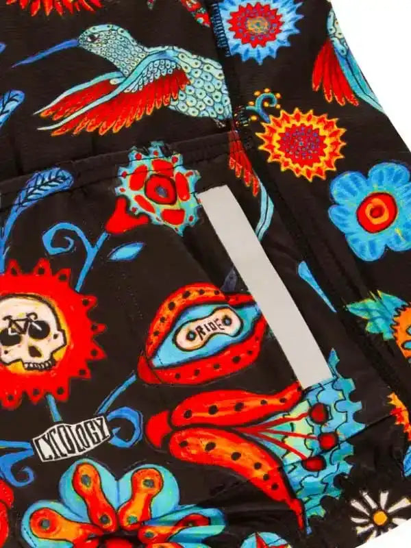 Vibrant floral and skull print cycling shorts with reflective strip, bold colors on black fabric