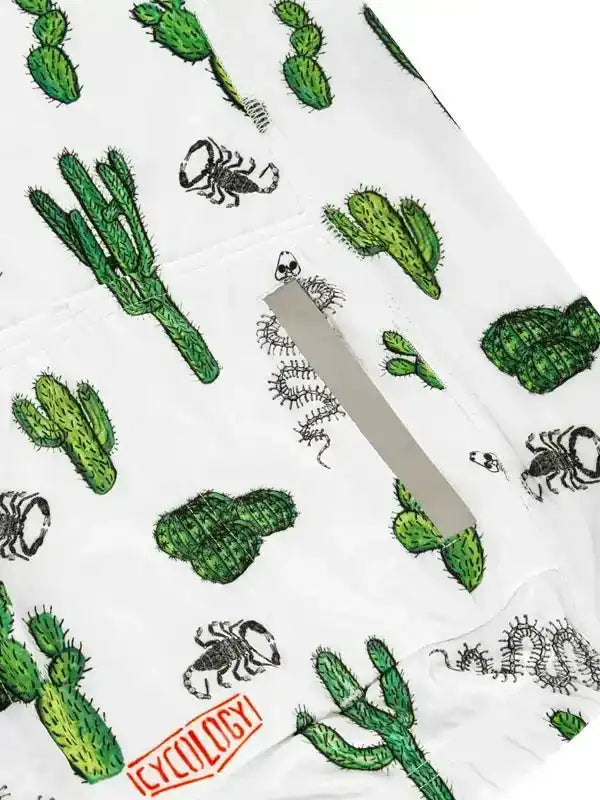 White cycling shorts with green cactus and black scorpion print, featuring a rear pocket and Cycology logo
