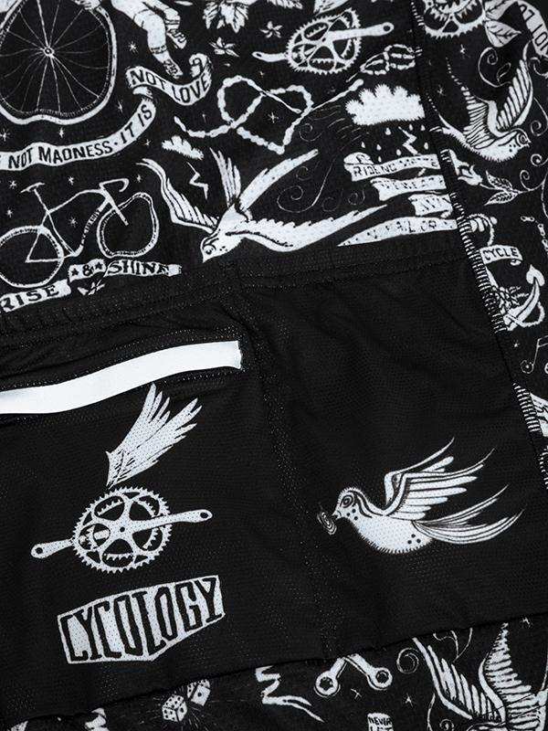 Black cycling shorts with white tattoo-style graphics, birds, gears, and 'Cycology' branding