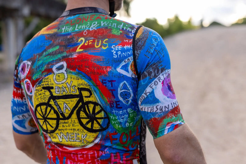 Men's colorful cycling jersey with bold graphics and text, featuring '8 Days a Week' and bike art, perfect for road rides.