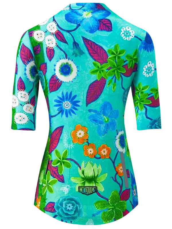 Women's cycling jersey with vibrant floral print, turquoise base, and 3/4 sleeves for bike rides