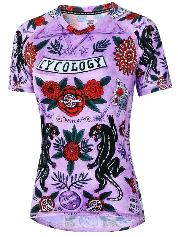 Purple women's cycling jersey with floral and panther tattoo-style print, featuring 'Cycology' logo and bold graphics.