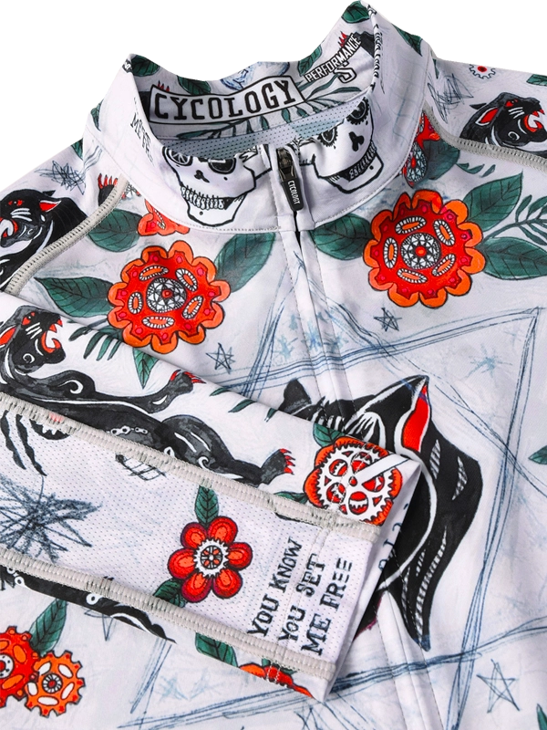 Close-up of Long-sleeve cycling jersey with floral and panther design on a grey background