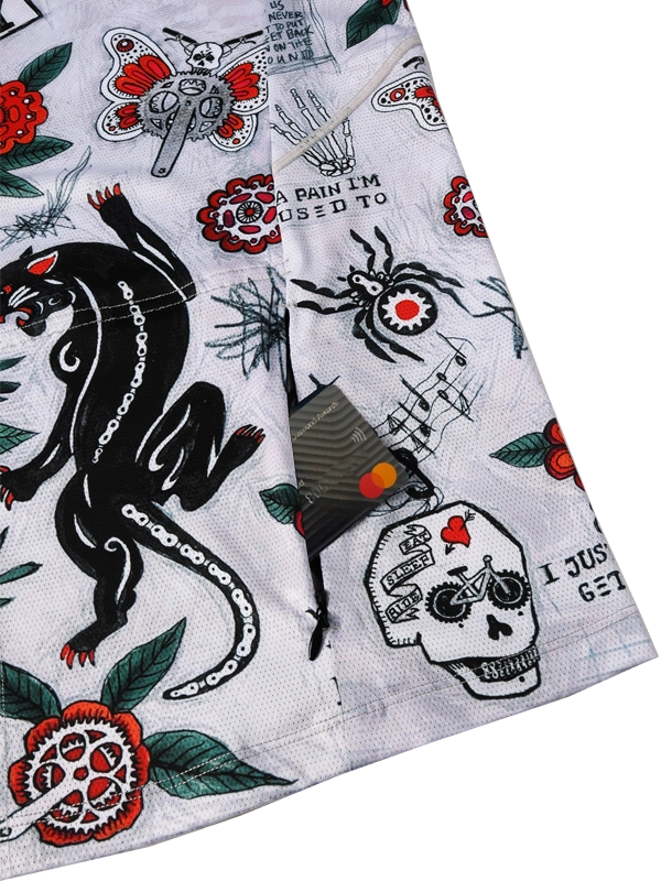 Close-up of a fabric with tattoo-style designs including a panther, skull, and text and back zip pocket