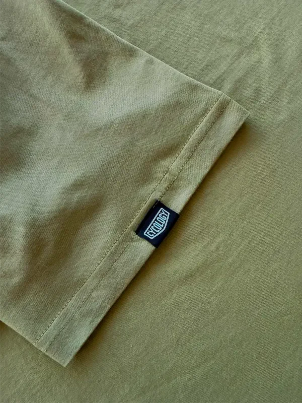 Olive green cycling shirt sleeve with black Cycology brand tag, showcasing quality stitching and fabric detail.