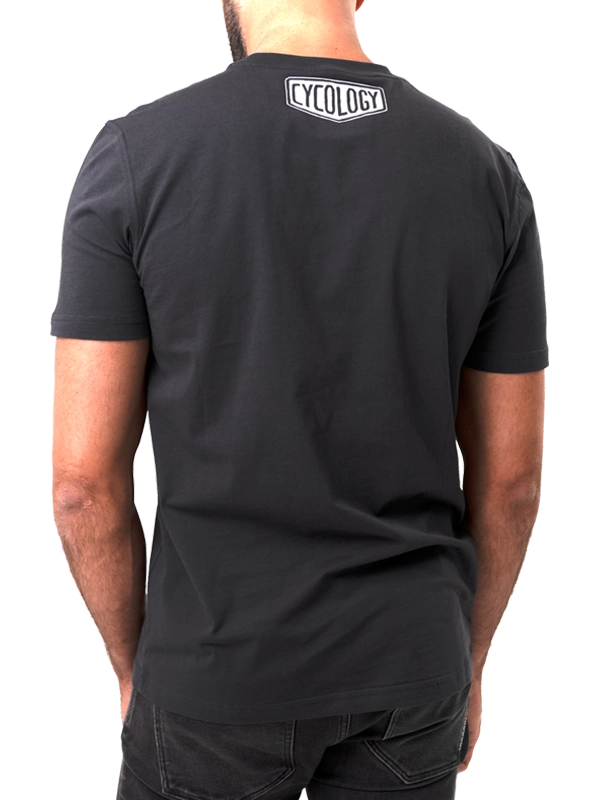 Person wearing a black t-shirt with 'Cycology' logo on the back, 