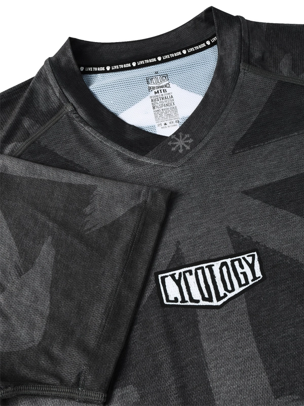 Close-up of a black and gray MTB  shirt with 'Cycology' logo