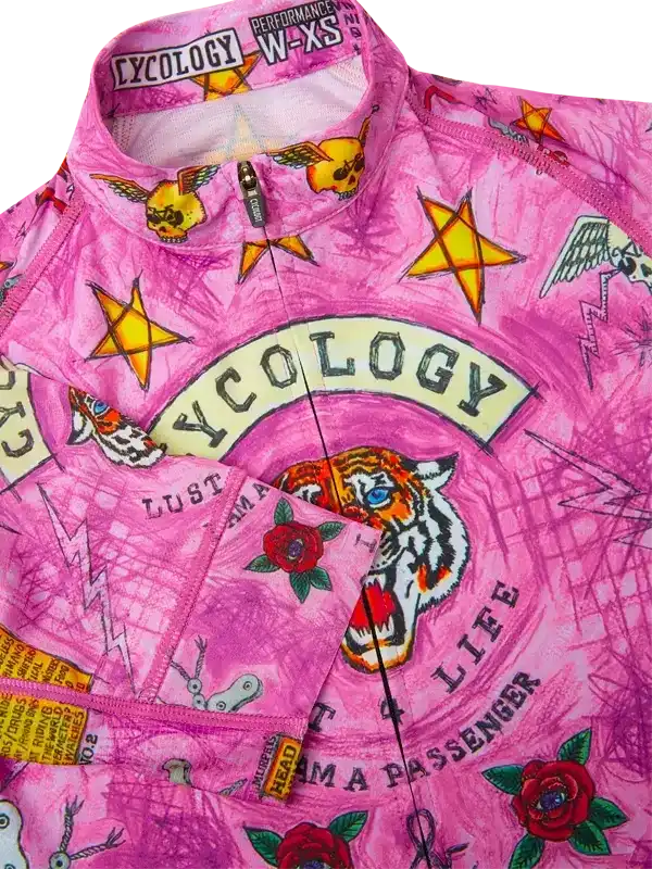 Pink women's cycling jersey with tiger, roses, stars, and tattoo-style graphics, performance fit