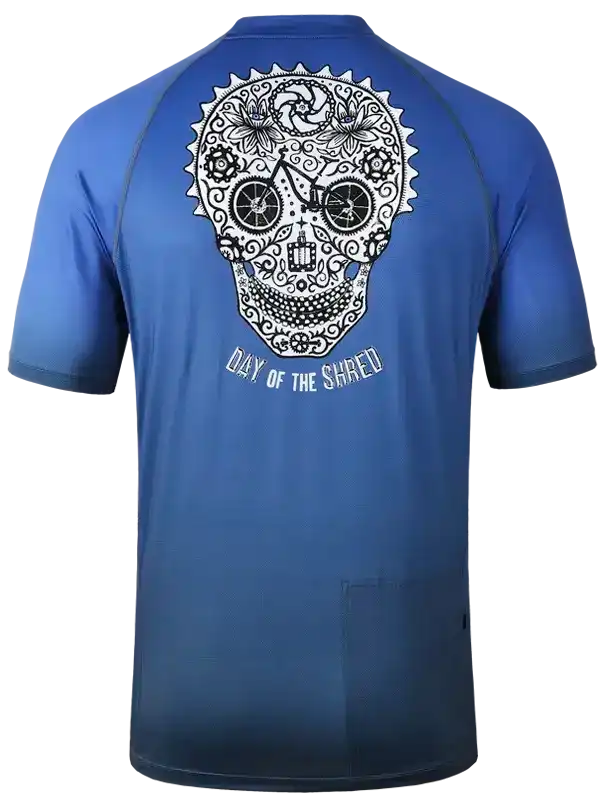 Blue cycling jersey with sugar skull design and 'Day of the Shred' text