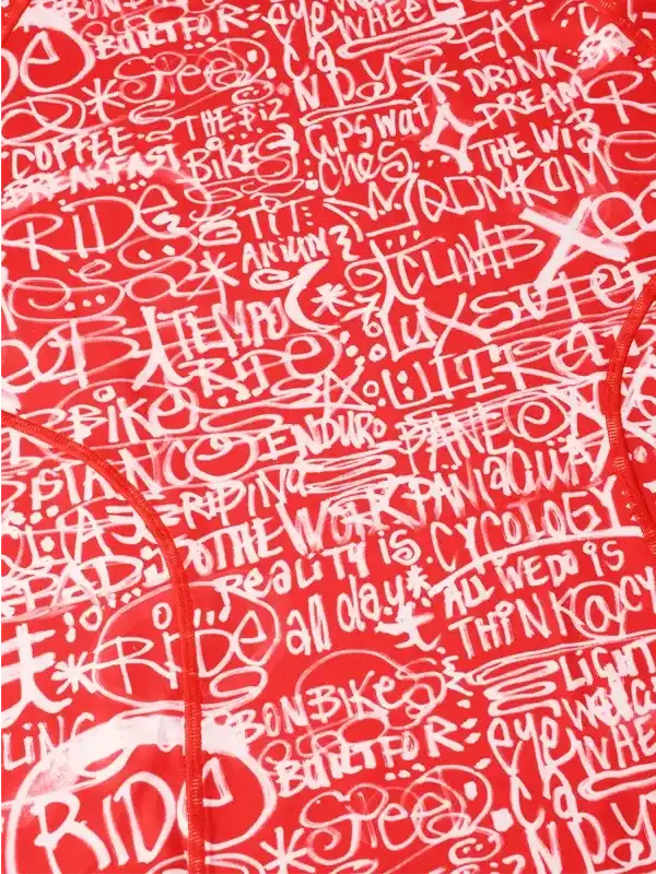 Red cycling jersey with white graffiti-style cycling phrases and graphics, ideal for men's and women's bike rides