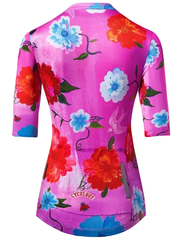 Women's cycling jersey with vibrant floral print, pink base, blue and red flowers, 3/4 sleeves, reflective details