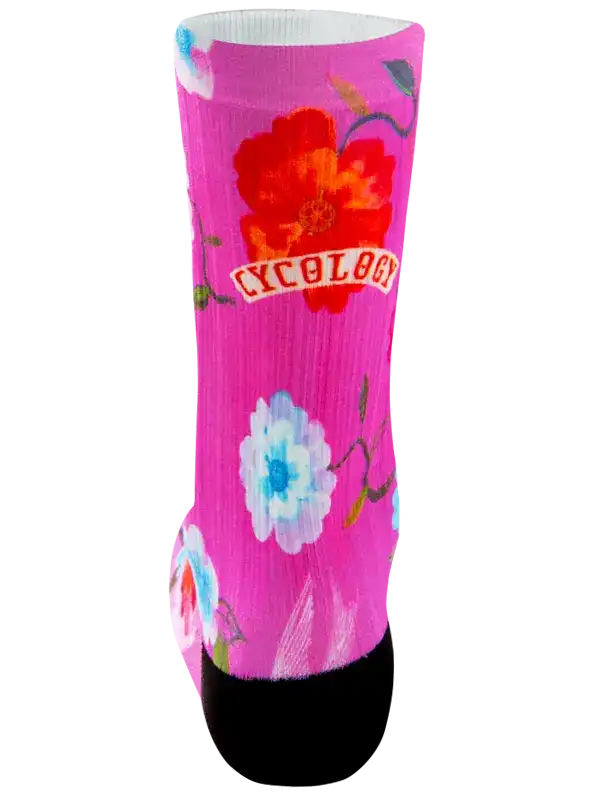Pink floral cycling sock with 'CYCOLOGY' logo, black toe, vibrant flower print for women's bike wear