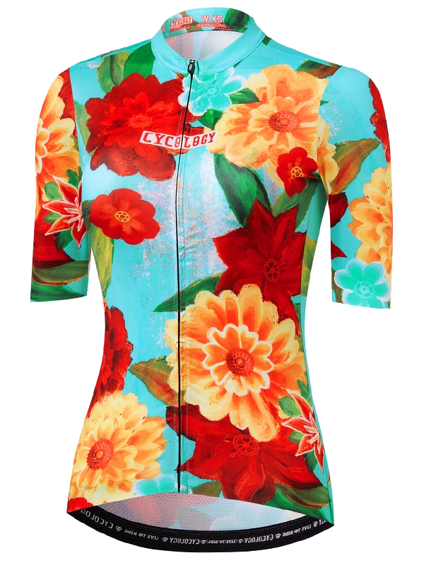Colorful women's floral-patterned cycling jersey with 'Cycology' branding on a aqua background
