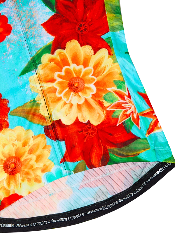 Colorful women's floral-patterned cycling jersey with 'Cycology' branding on a aqua background