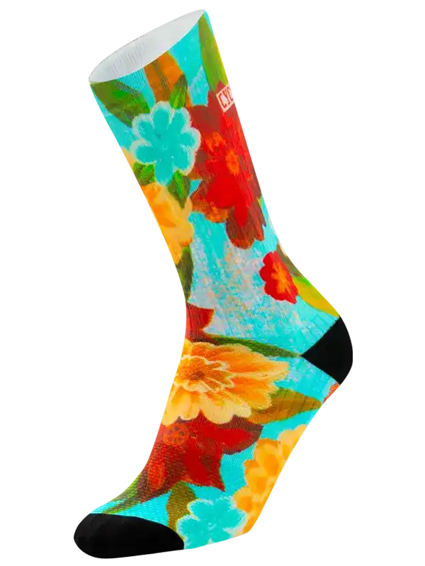 Colorful floral cycling socks with vibrant blooms on turquoise background, perfect for bike rides