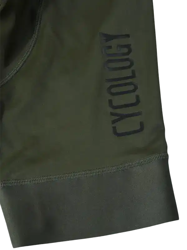 Olive green cycling shorts with 'CYCOLOGY' logo, high-quality fabric, performance design