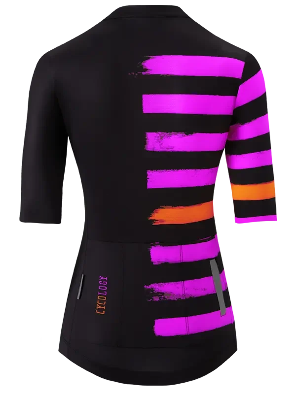 Women's cycling jersey with bold pink and orange brushstroke stripes on black, 3/4 sleeves, rear pockets