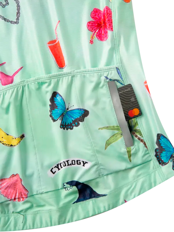 Green jacket with colorful butterfly and shell patterns, featuring a visible brand label.