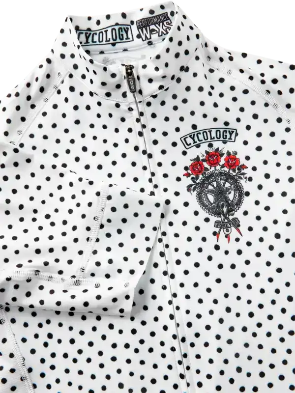 White polka dot cycling jersey with red rose graphic and zipper detail