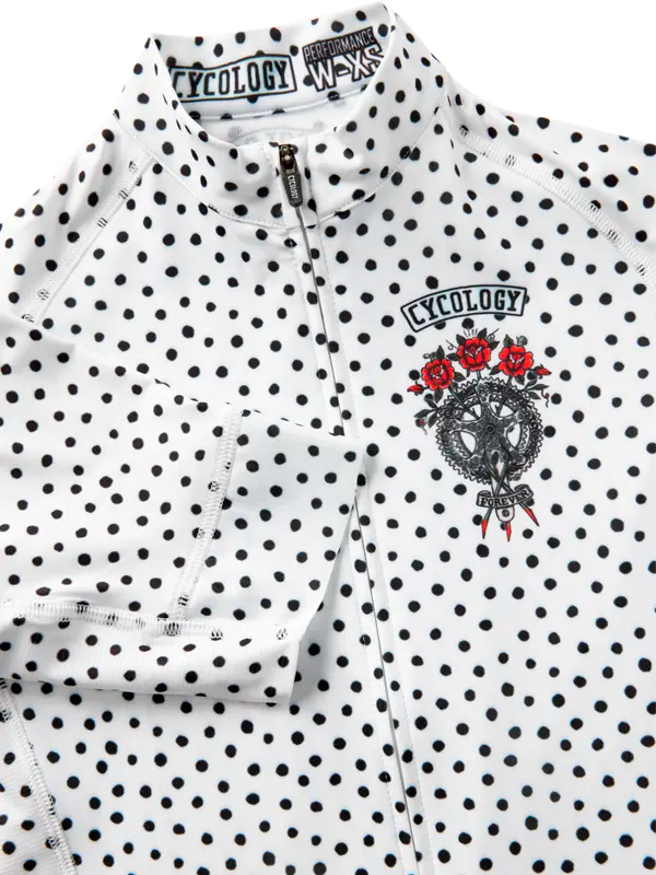 White polka dot shirt with black text and logo on a white background