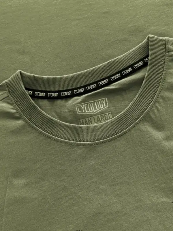 Close-up of a green t-shirt with 'Cycology' branding on the collar.