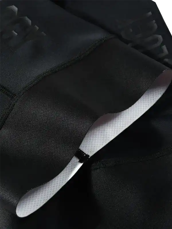 Close-up of a black gripper cuff and embossed tonal branding.