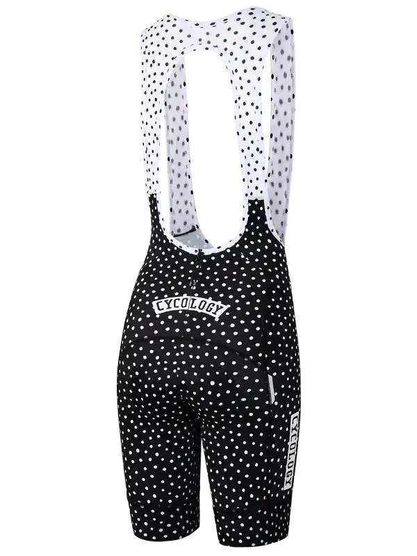 Black and white polka dot women's cycling bib shorts with brand logo, designed for comfort and performance.
