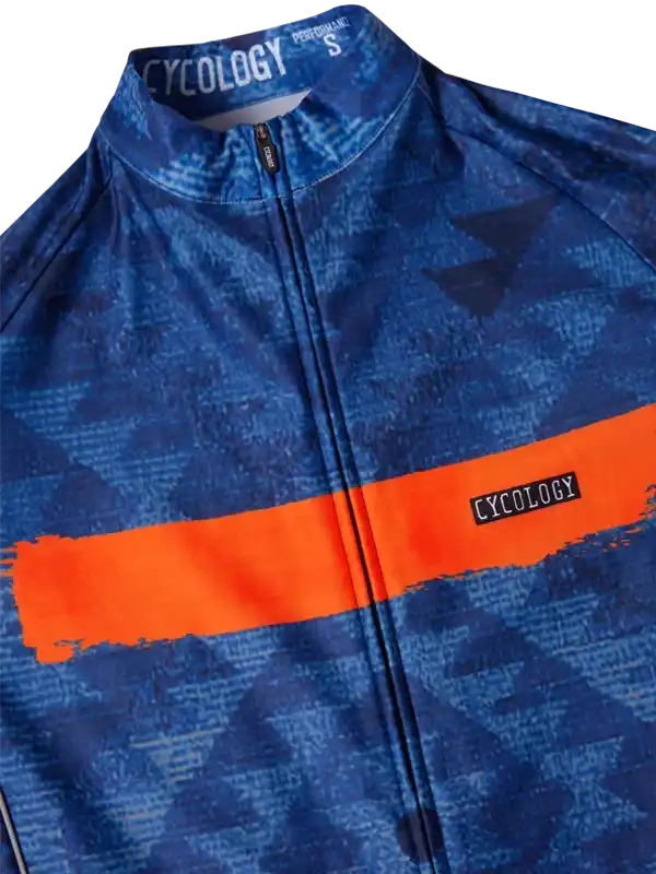 Blue cycling jersey with orange stripe, geometric pattern, and CYCOLOGY branding on collar and chest