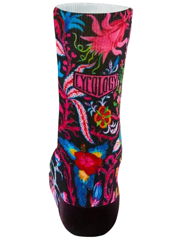 Vibrant floral cycling sock with bold pink, blue, and red patterns on black background, featuring 'CYCOLOGY' logo.