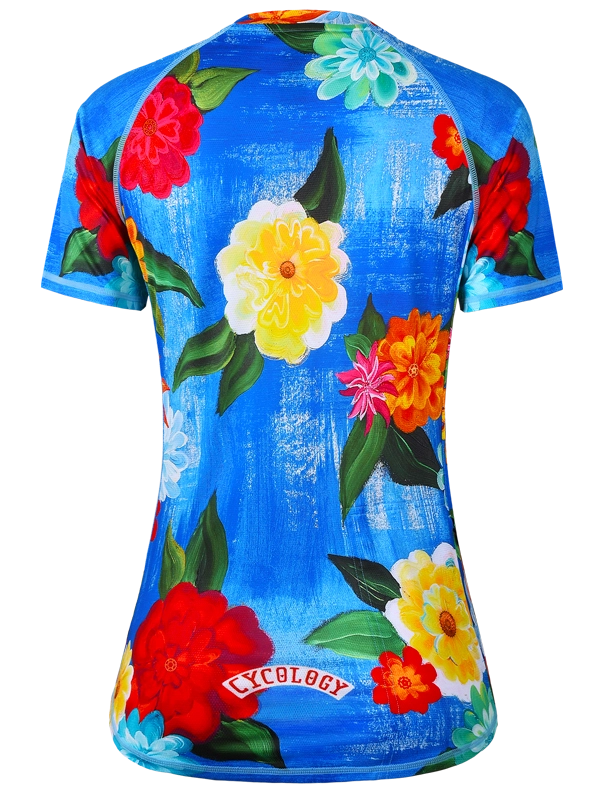 Women's colorful floral MTB jersey with 'Cycology' branding on a blue background