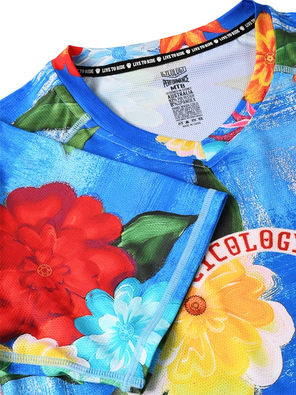 Women's colorful floral MTB jersey with 'Cycology' branding on a blue background