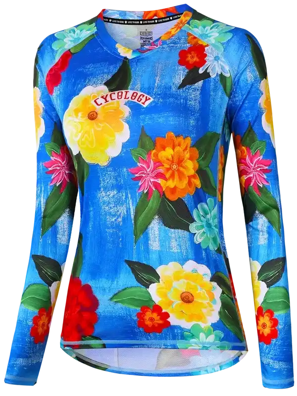Women's long sleeve cycling jersey with vibrant floral print on blue background, featuring breathable fabric and athletic fit