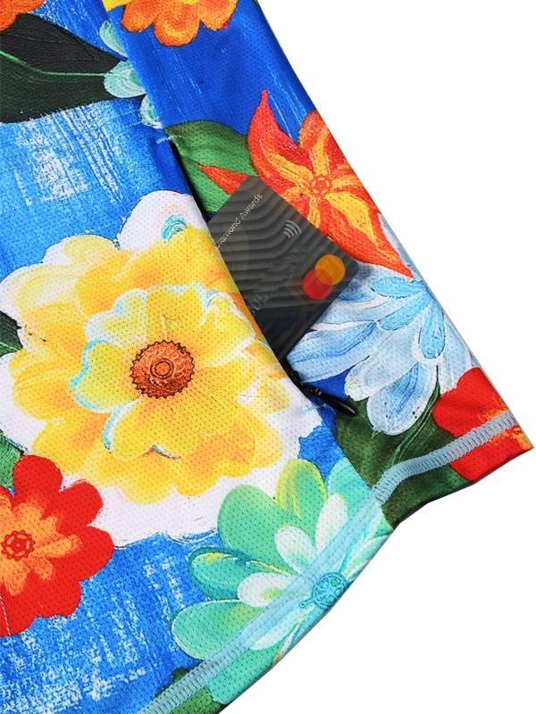 Close-up of a colorful floral fabric with vibrant flowers on a blue background and back zip pocket