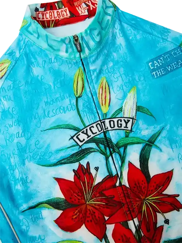 Blue cycling jersey with red lily print, floral design, and 'CYCOLOGY' logo for men's or women's bike wear