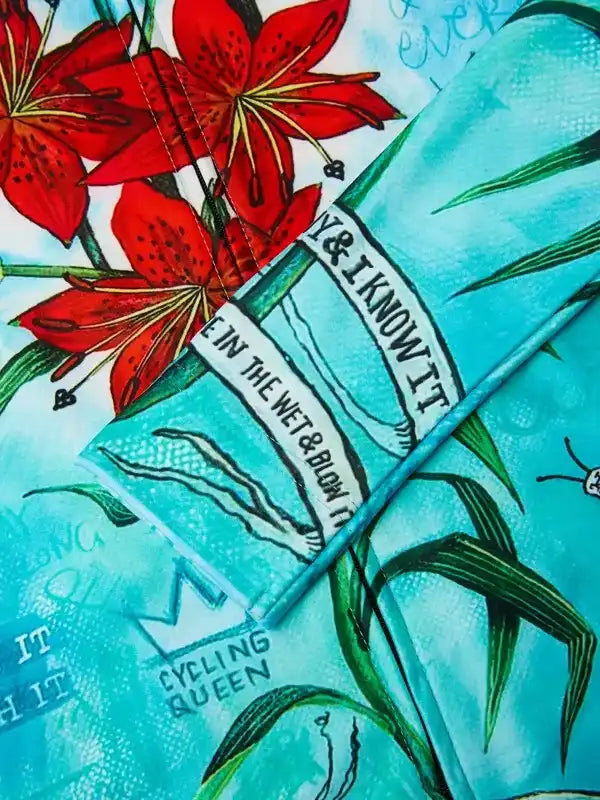 Cycling Queen apparel with vibrant red lilies and teal design, perfect for cycling enthusiasts.