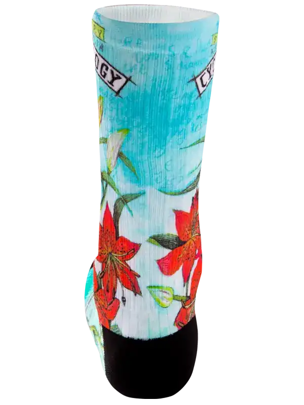 Cycling sock with vibrant red lily floral print on turquoise background, black toe and heel, ideal for bike rides